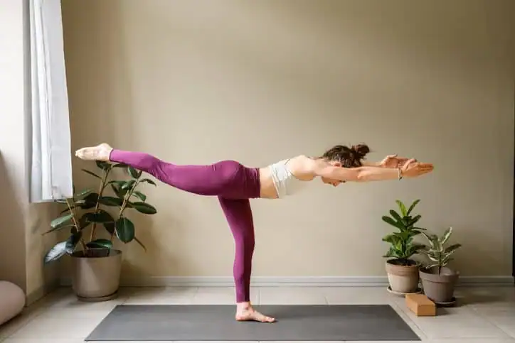 Achieving the Perfect Tone: How Often Should You Exercise for Results? 1 Woman doing Yoga exercise Sandwich to help with toning the body.